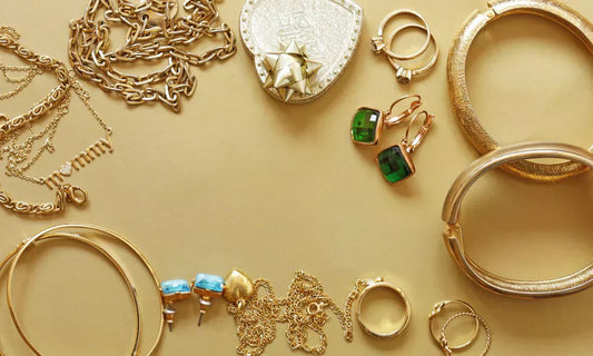 capsule jewelry with neatly arranged timeless pieces including rings, earrings, and chains.