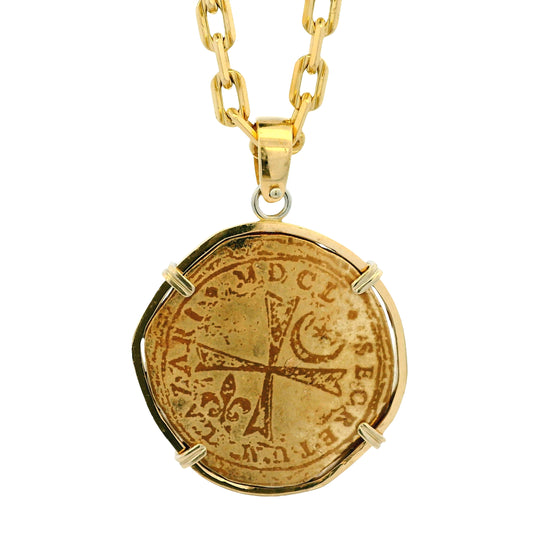 Gold necklace with a coin pendant on a white background