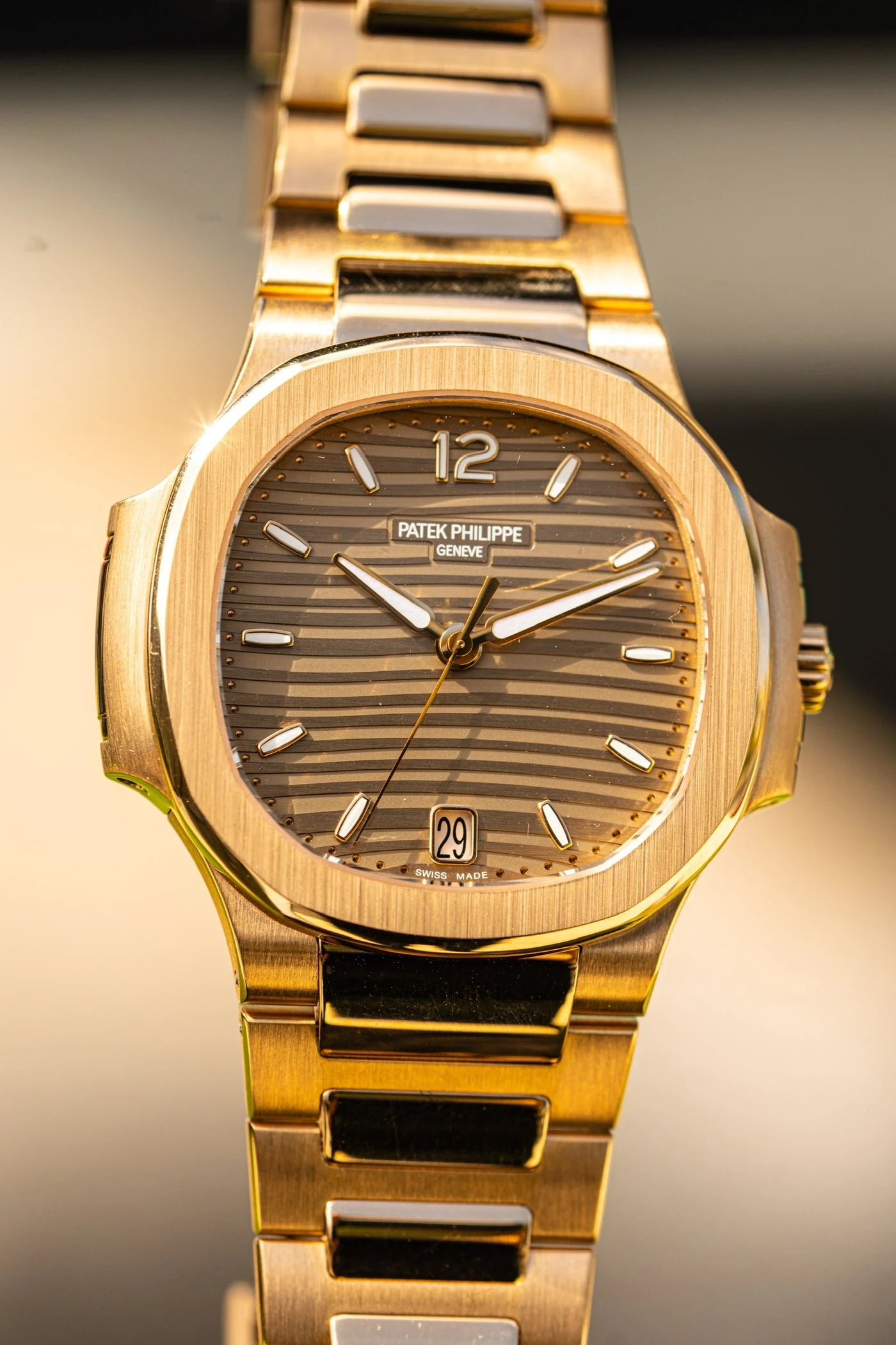 Patek Philippe watch with a brown dial and gold tone case