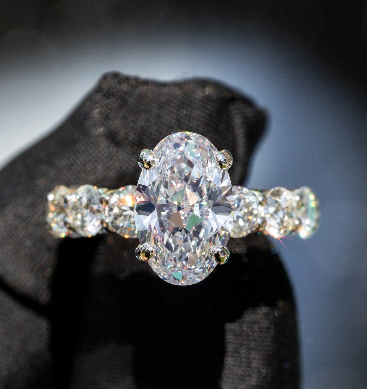 Ring with an oval center stone and smaller surrounding stones
