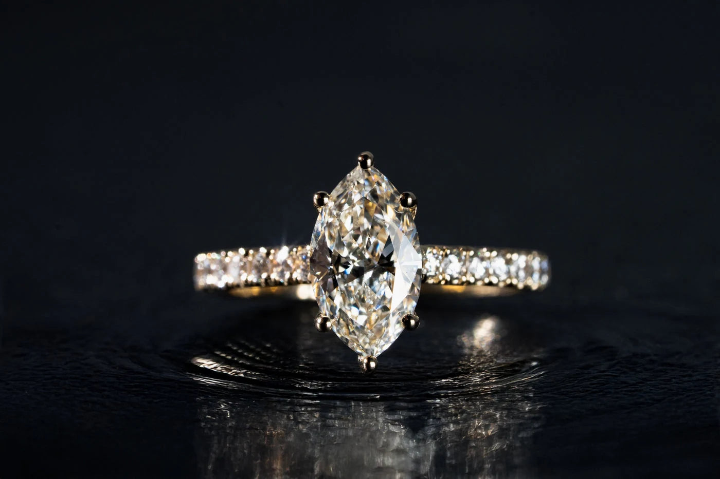 Ring with a large center stone and a pavé band
