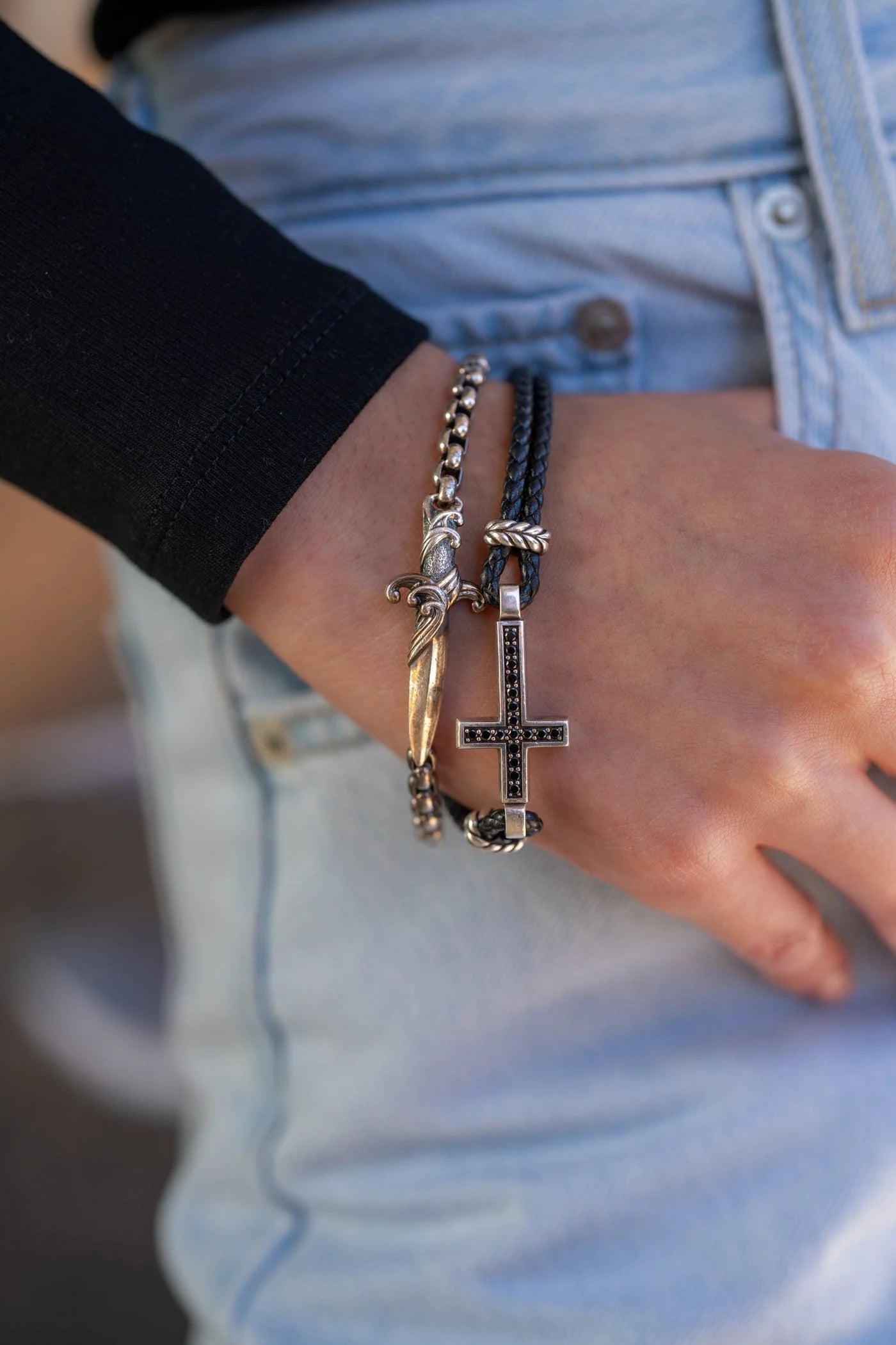 Cross pendant and chain displayed across a hand