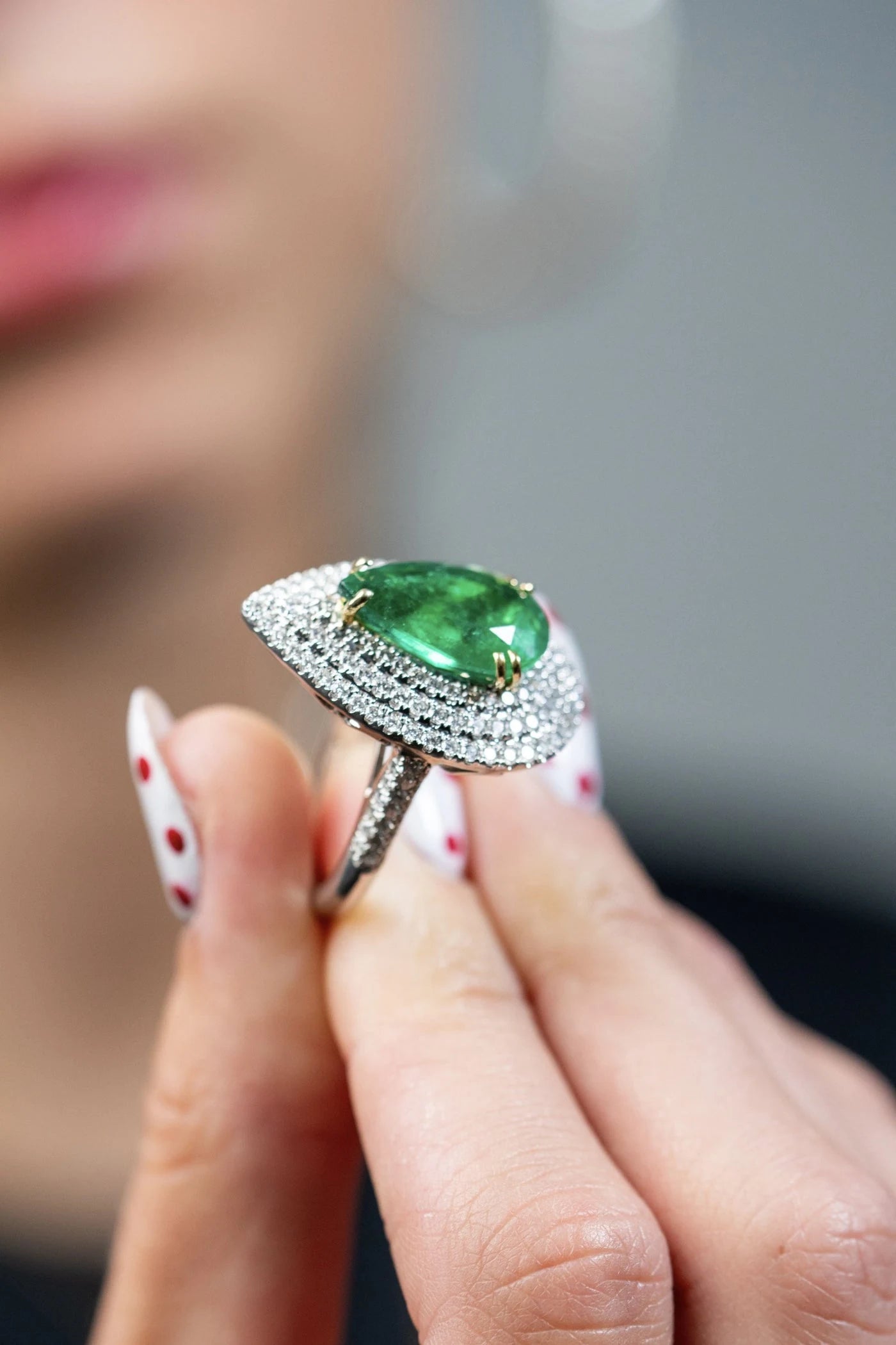 Green center stone ring viewed at an angle to show its raised setting