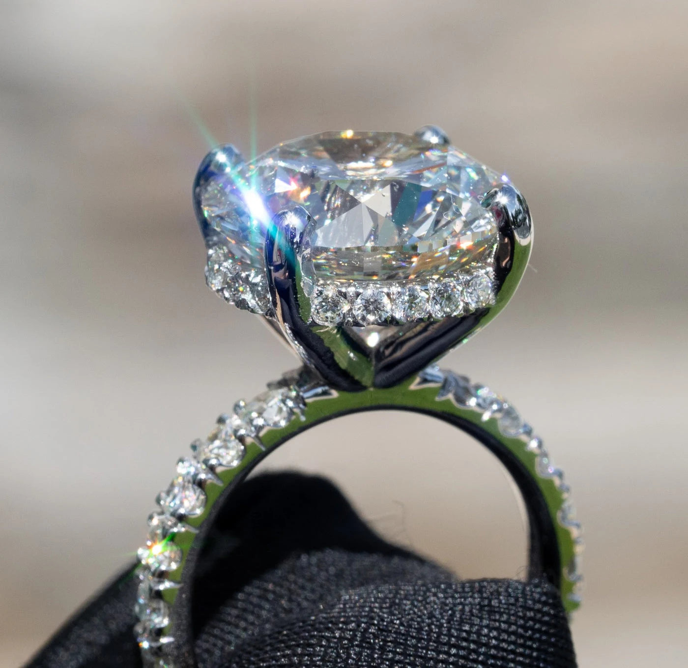 Side view of a ring with a large center stone and smaller stones in the setting