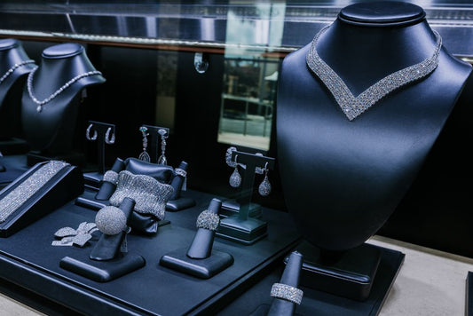 Necklaces, earrings, bracelets and rings arranged in a jewelry display case.