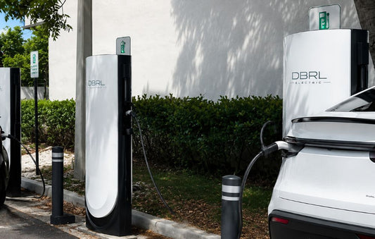 A white Tesla connected to a DBRL Electric charging pedestal.