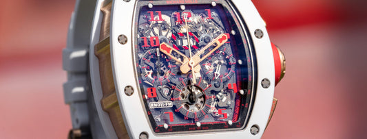 Close view of the Richard Mille RM011-FM dial with red numerals and white bezel.