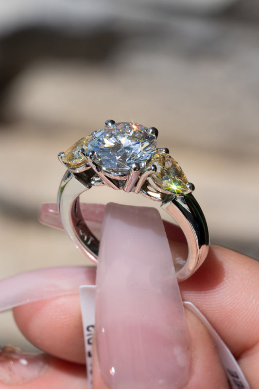 three-stone ring with round and pear diamonds