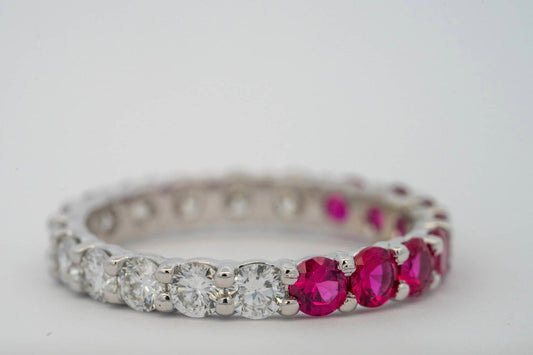 Red and clear round stones set around a band.