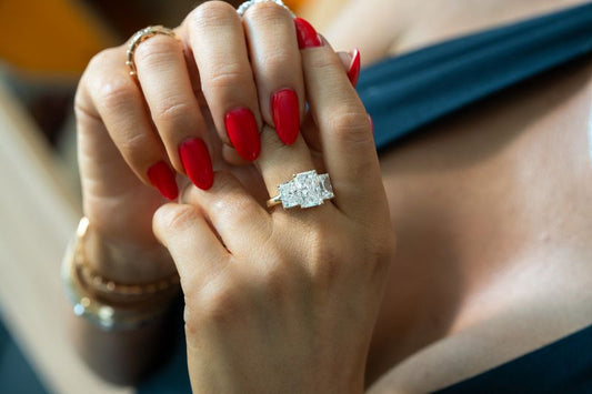 A rectangular clear center stone in a ring.