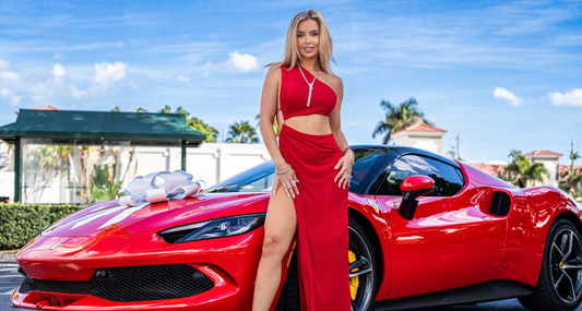 A model beside a red Ferrari.