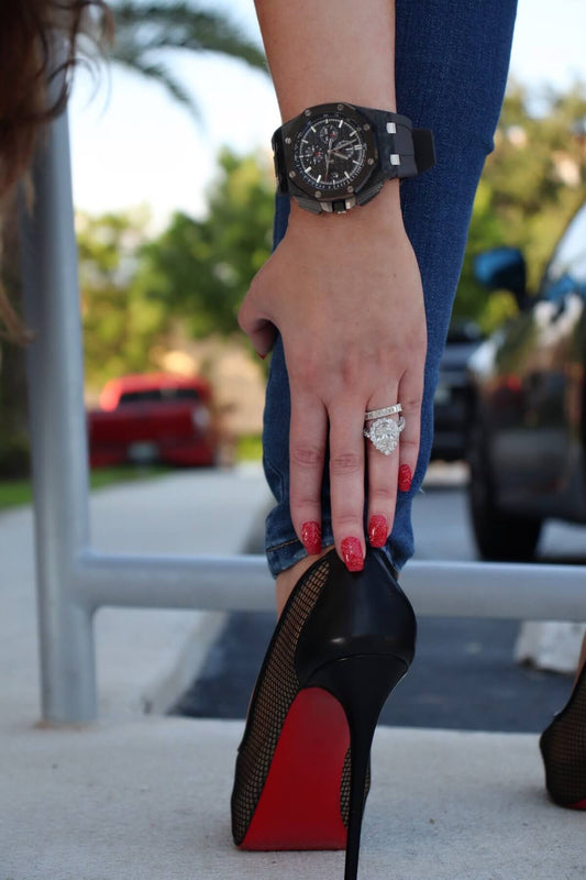 Watch and diamond ring styled with a black and red shoe.