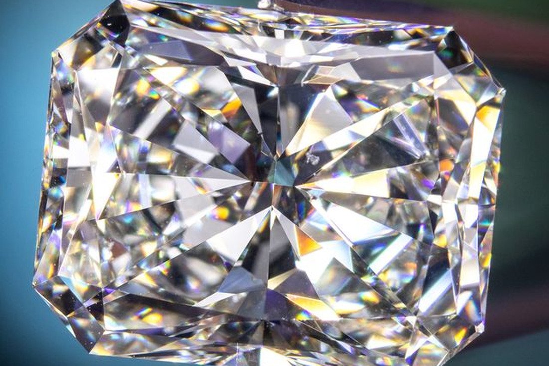 Close view of the facets of a rectangular clear gemstone.