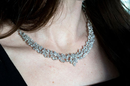 A necklace with floral clusters and pear shaped drops.