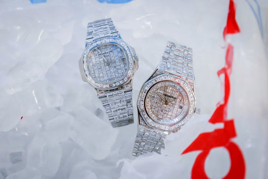 Two watches with stones covering their dials, bezels and bracelets.