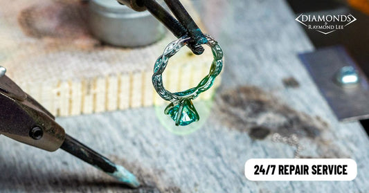 A ring held at a jewelry workbench in an older repair promotion.