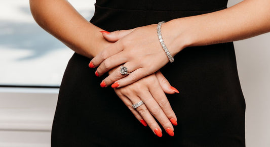 A ring, stone set band and bracelet worn together.