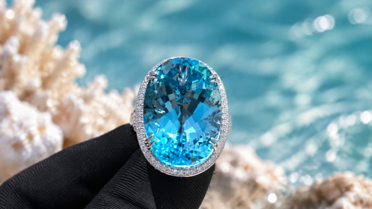 Oval blue center ring with a clear stone halo.