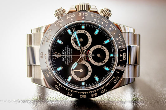 Close view of a Rolex Daytona with a black dial and black bezel.