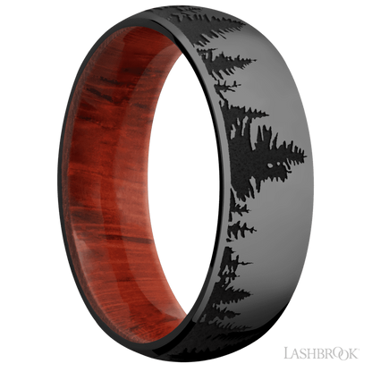 7 mm wide/Domed/Zirconium band with a laser carved Trees pattern also featuring a Padauk sleeve.