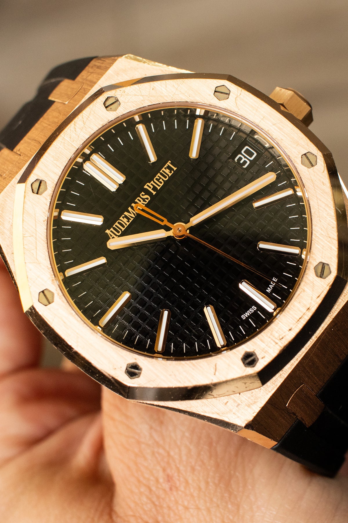 Audemars Piguet Royal Oak with a black dial and gold-tone case