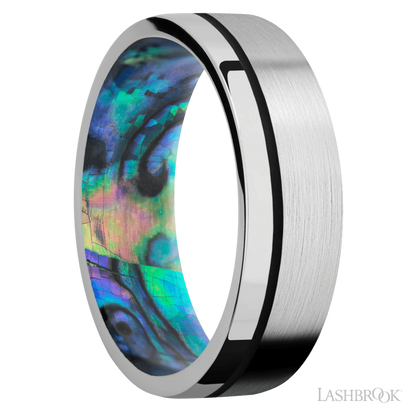 7 mm wide/Flat/14K White Gold band with one 0.5 mm Off Center inlay of Black also featuring a Abalone sleeve.