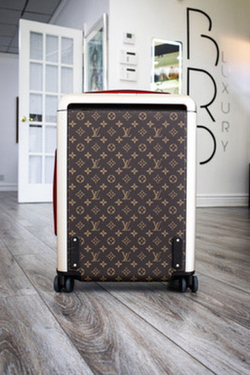 Brown Louis Vuitton monogram rolling suitcase in the showroom
