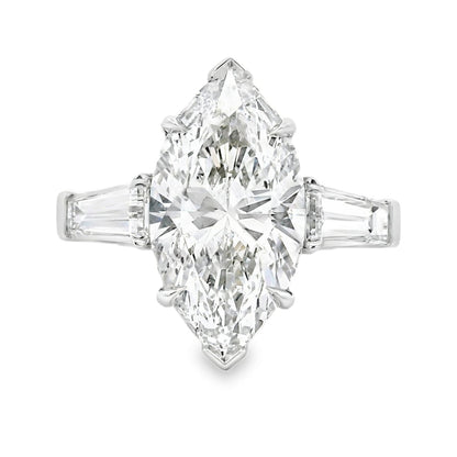 Diamond ring with a marquise-shaped center stone on a white background