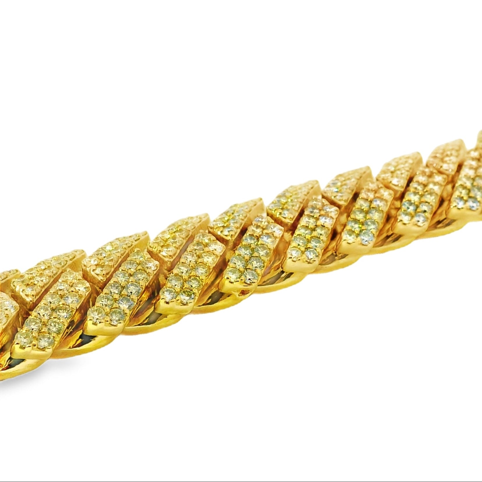 Gold bracelet with diamond-like stones on a white background