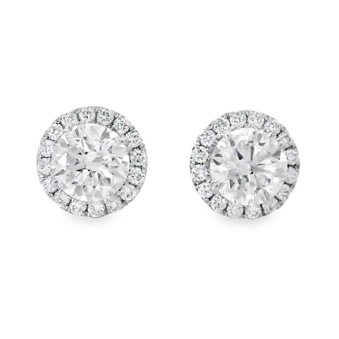 Pair of silver stud earrings with clear gemstones on a white background