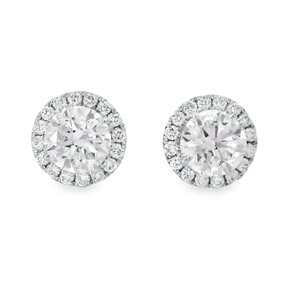 Pair of silver stud earrings with clear gemstones on a white background