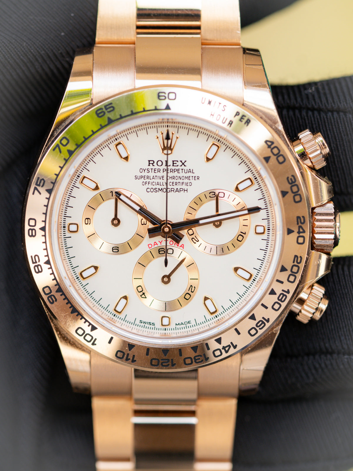 Close view of a Rolex Daytona with a light dial and gold colored case