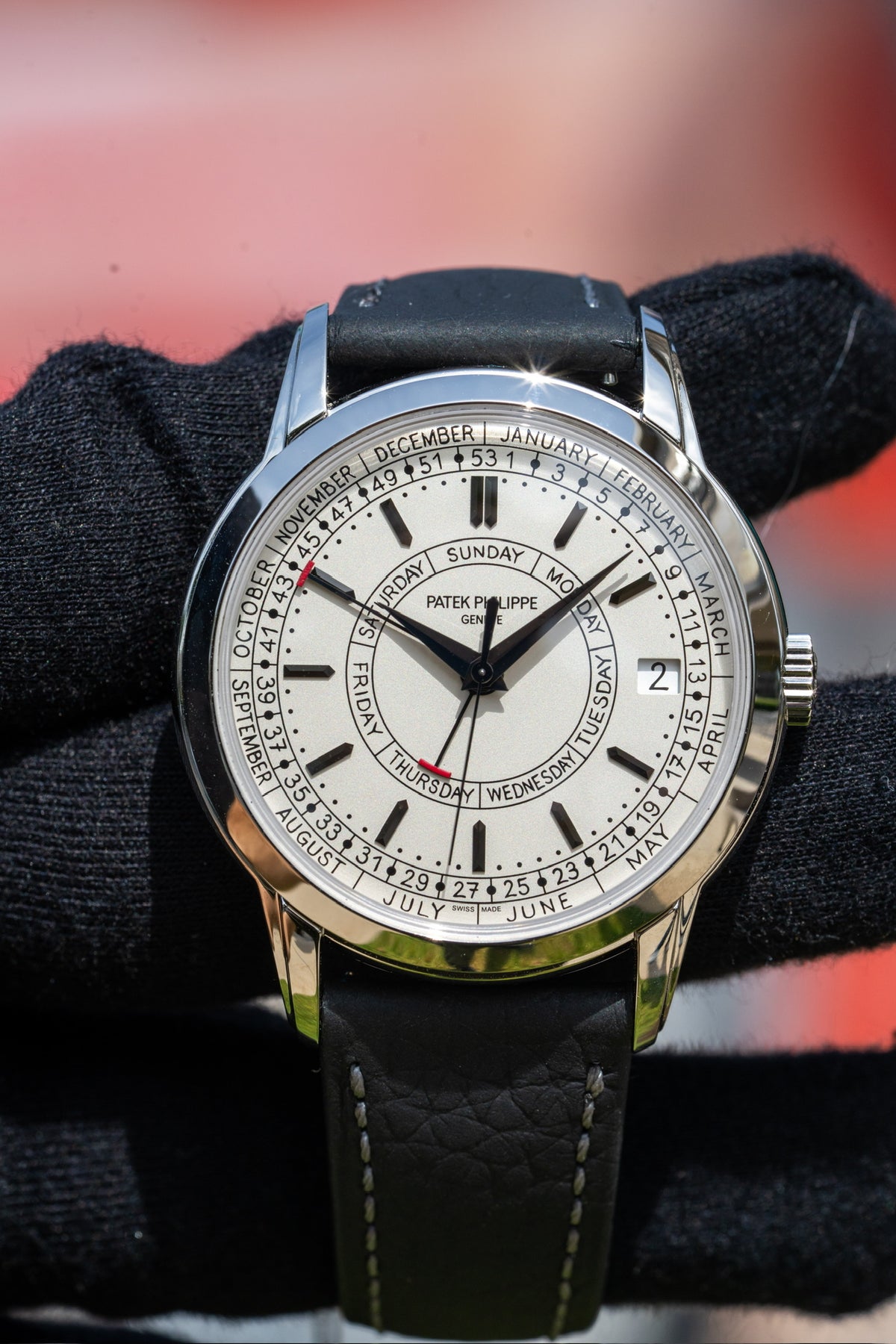Patek Philippe calendar watch with a light dial and dark leather strap