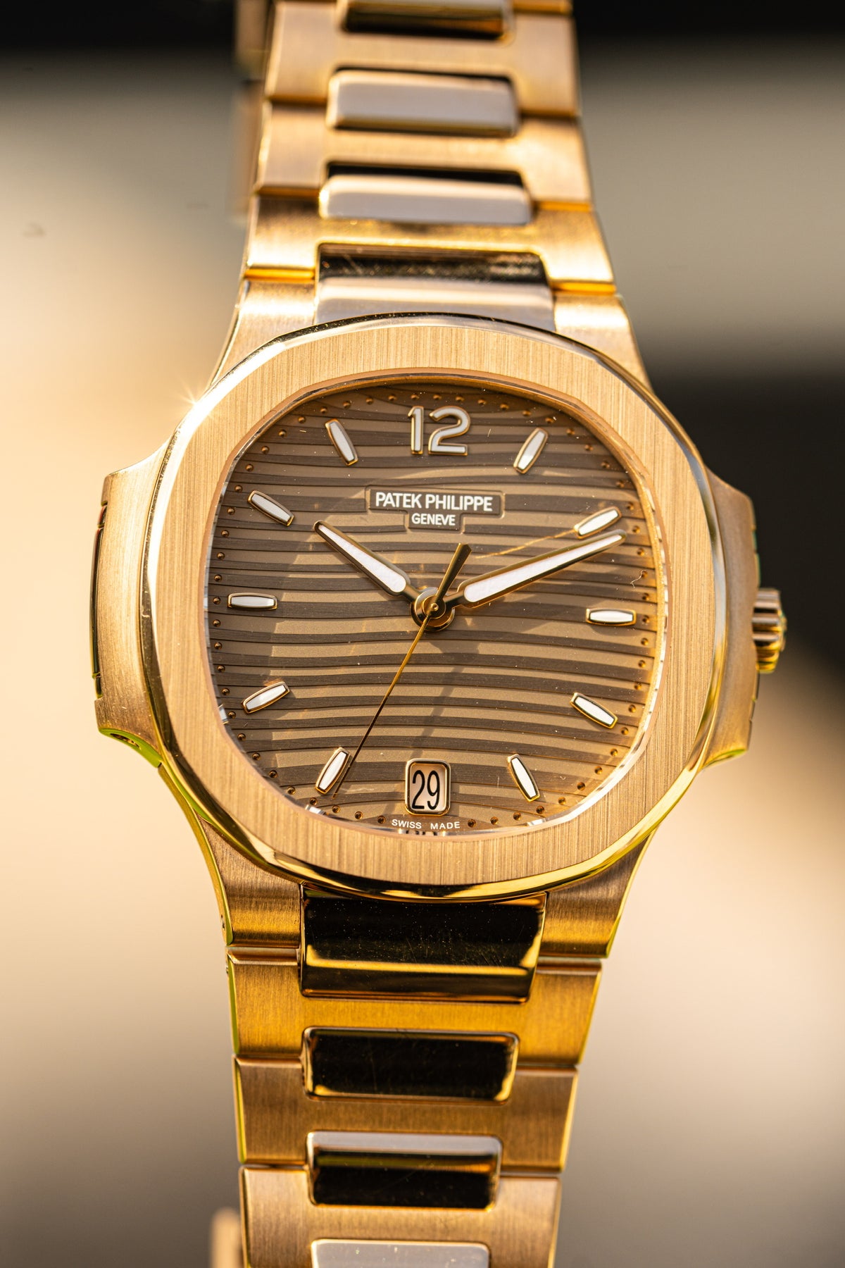 Patek Philippe watch with a brown dial and gold tone case