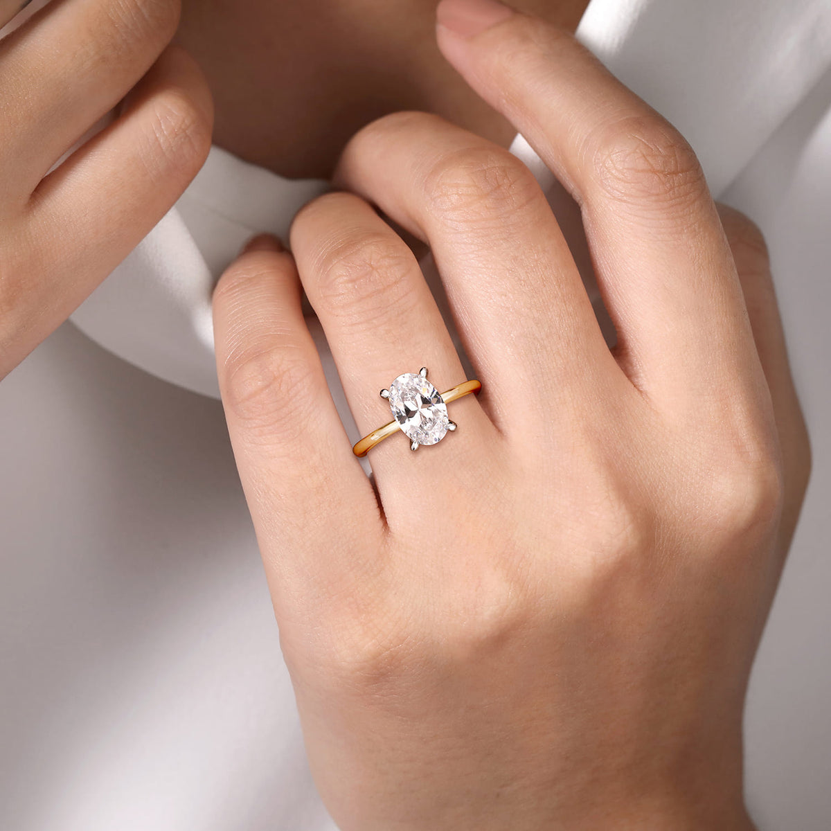 14K White-Yellow Gold Oval Solitaire Diamond Engagement Ring — Gabriel & Co. ER15972O8M44JJ; center stone shown for illustration, not included