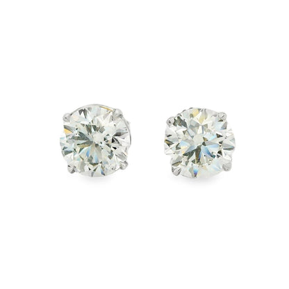 Pair of diamond stud earrings on a white background