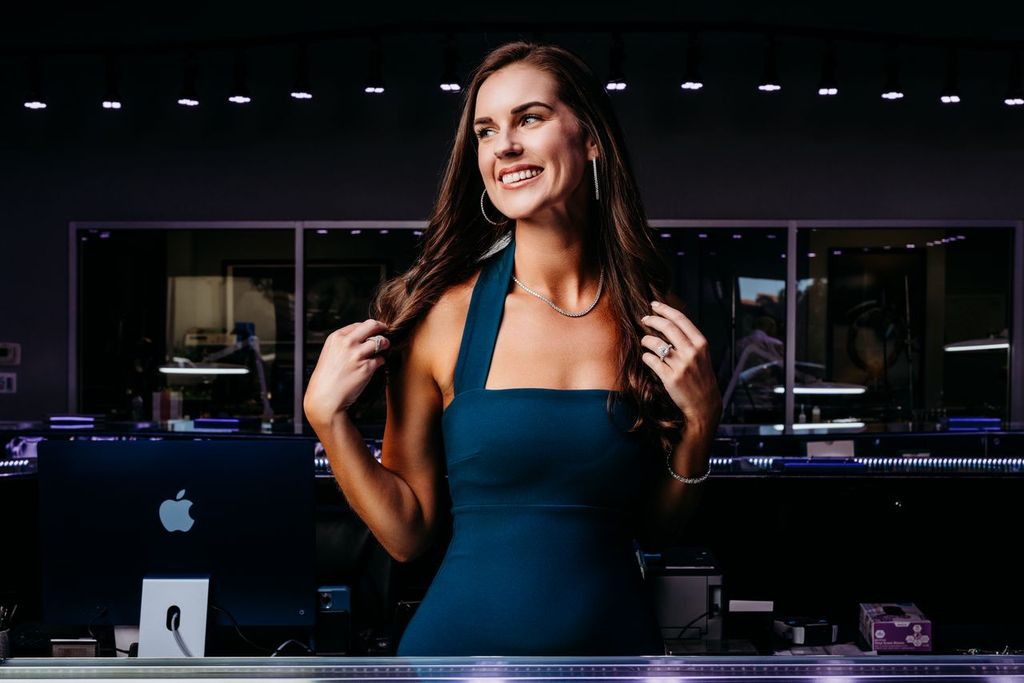 Model wearing jewelry at a showroom display counter