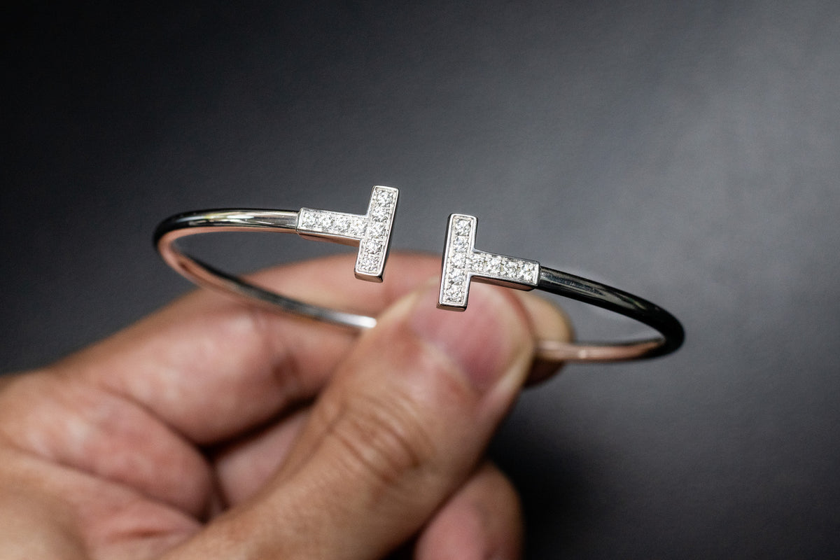 Tiffany T bracelet held between two fingers