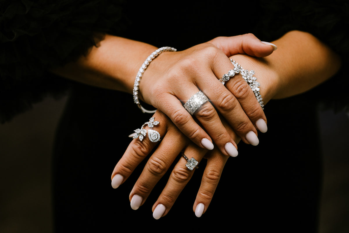 Diamond rings and bracelets worn together during a jewelry styling session
