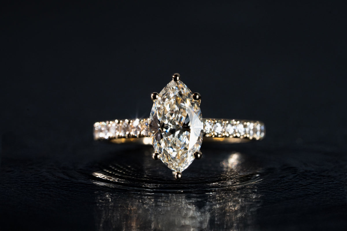 Ring with a large center stone and a pavé band