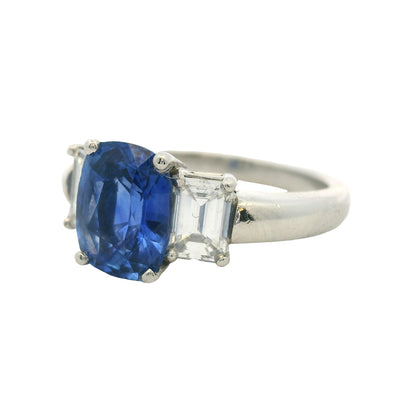 Platinum 3 Stone Ring set with Natural Cushion Blue Sapphire and Emerald Cut Diamond Side Stones