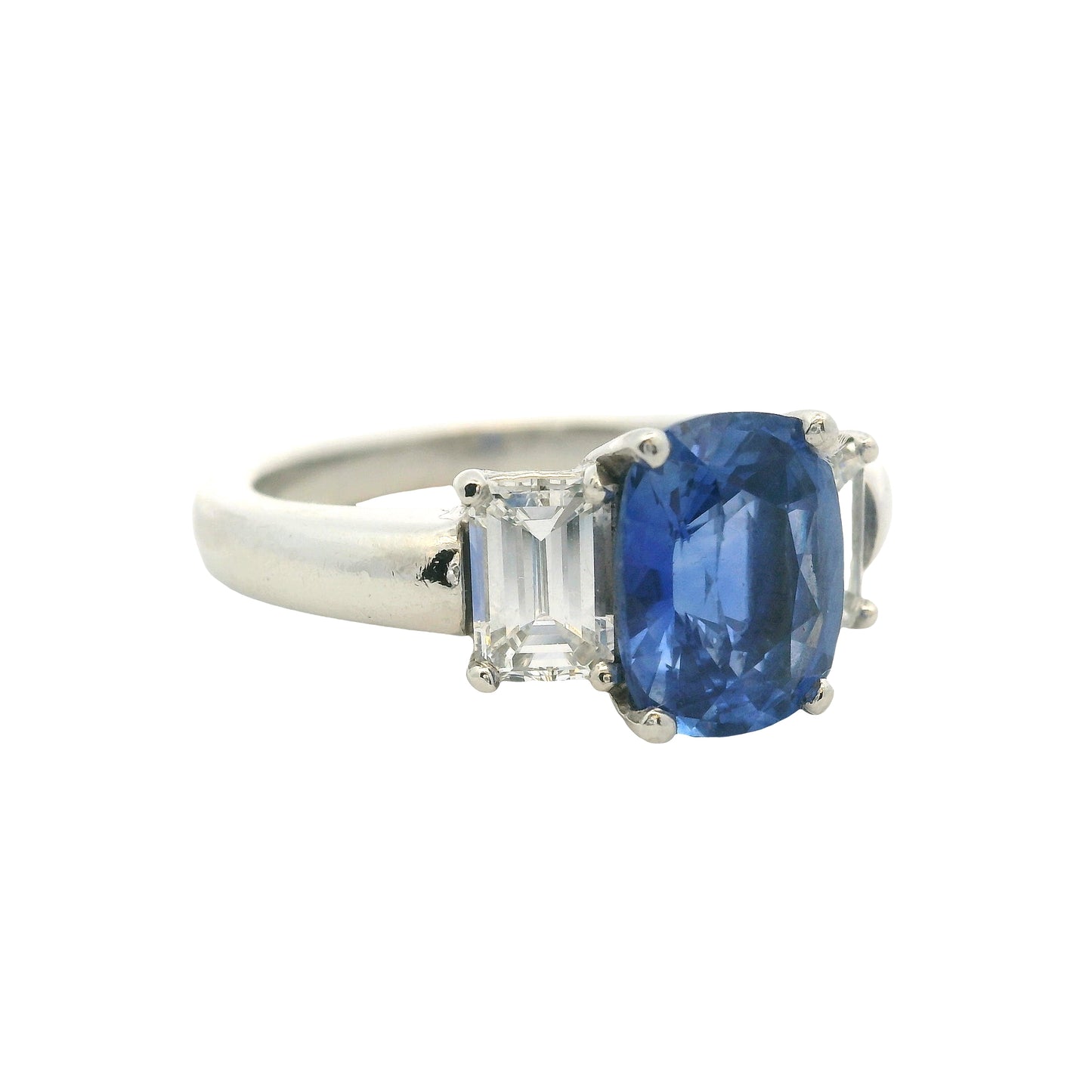 Platinum 3 Stone Ring set with Natural Cushion Blue Sapphire and Emerald Cut Diamond Side Stones