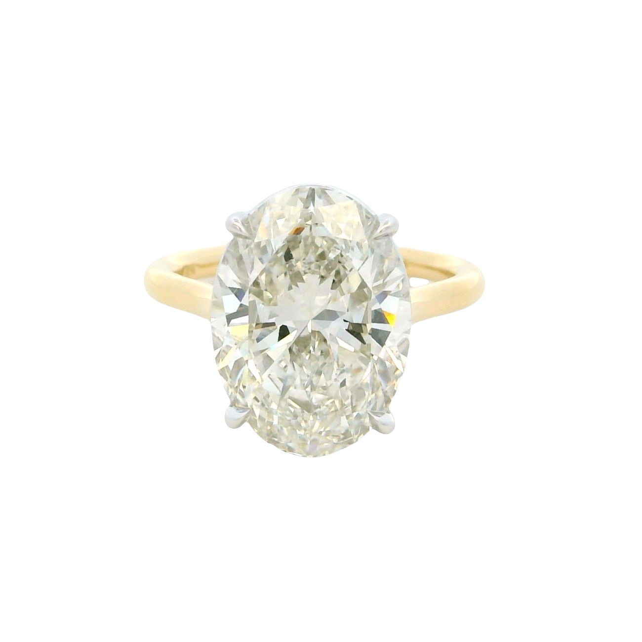 Diamond ring with yellow gold band on a white background