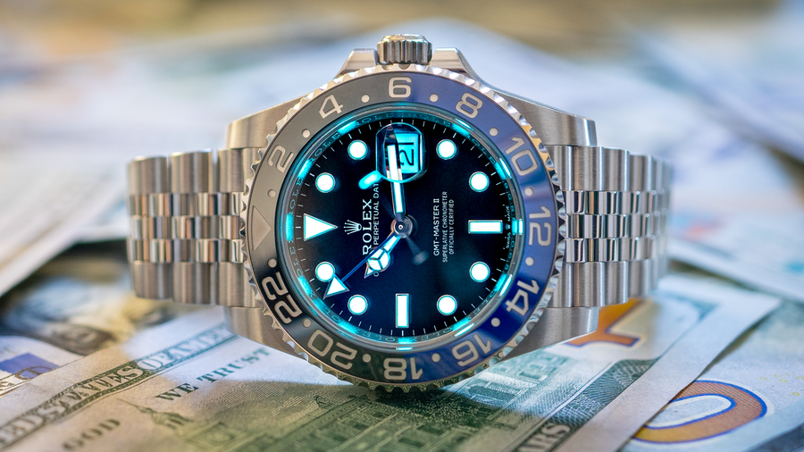 Rolex GMT Master II with a blue and black bezel on banknotes