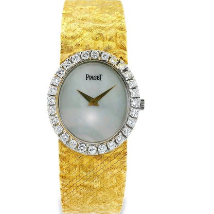 Gold watch with diamond bezel on a white background