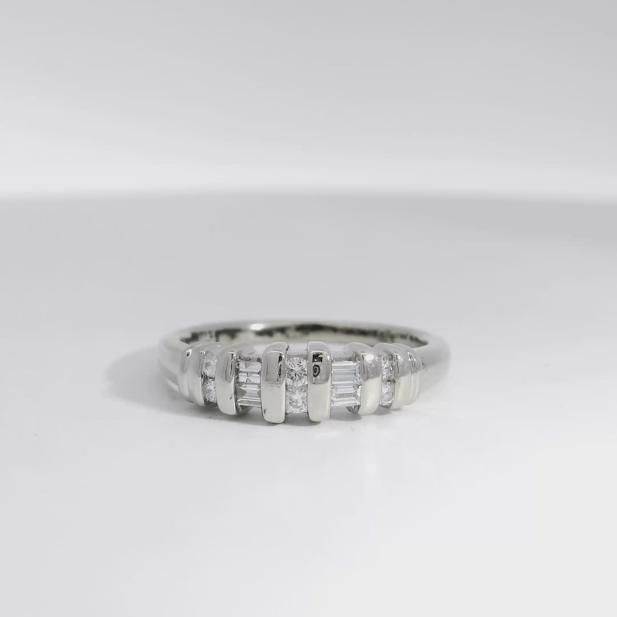 Baguette and round brilliant diamond ring 360 view on white background