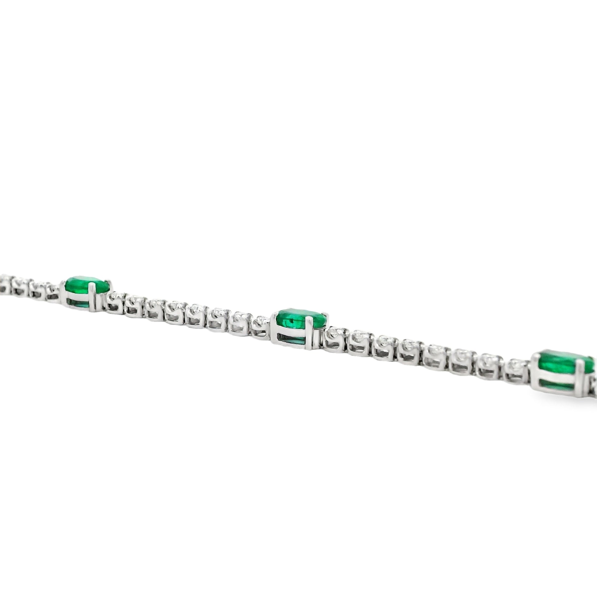 14k White Gold 5.88ctw Oval Emerald and Round Brilliant Diamond Tennis Bracelet — front view, clasp closed