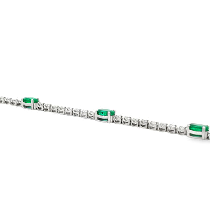 14k White Gold 5.88ctw Oval Emerald and Round Brilliant Diamond Tennis Bracelet — front view, clasp closed