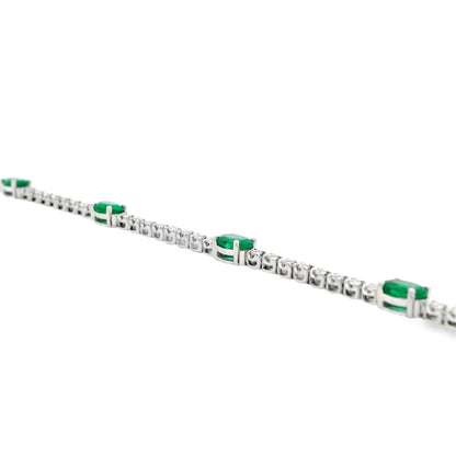 14k White Gold 5.88ctw Oval Emerald and Round Brilliant Diamond Tennis Bracelet — left three-quarter angle