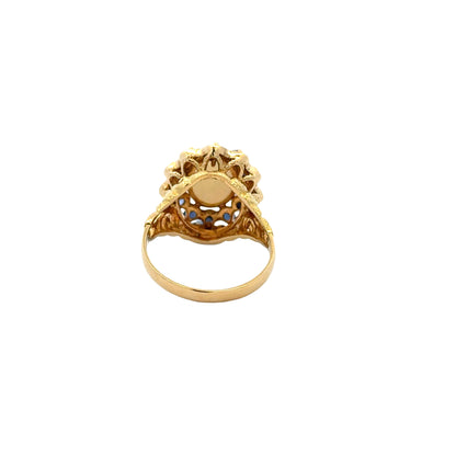 Vintage 18k Yellow Gold Opal and Blue Sapphire Halo Cocktail Ring — worn on the finger